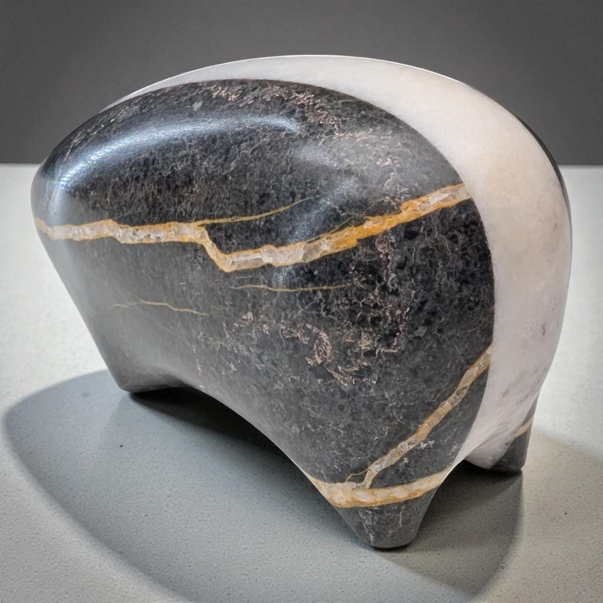 Decorative stone sculpture with a gray and white color scheme on a neutral background