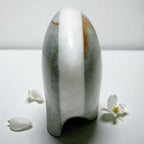 Marble-patterned ceramic vase on a white surface with flowers