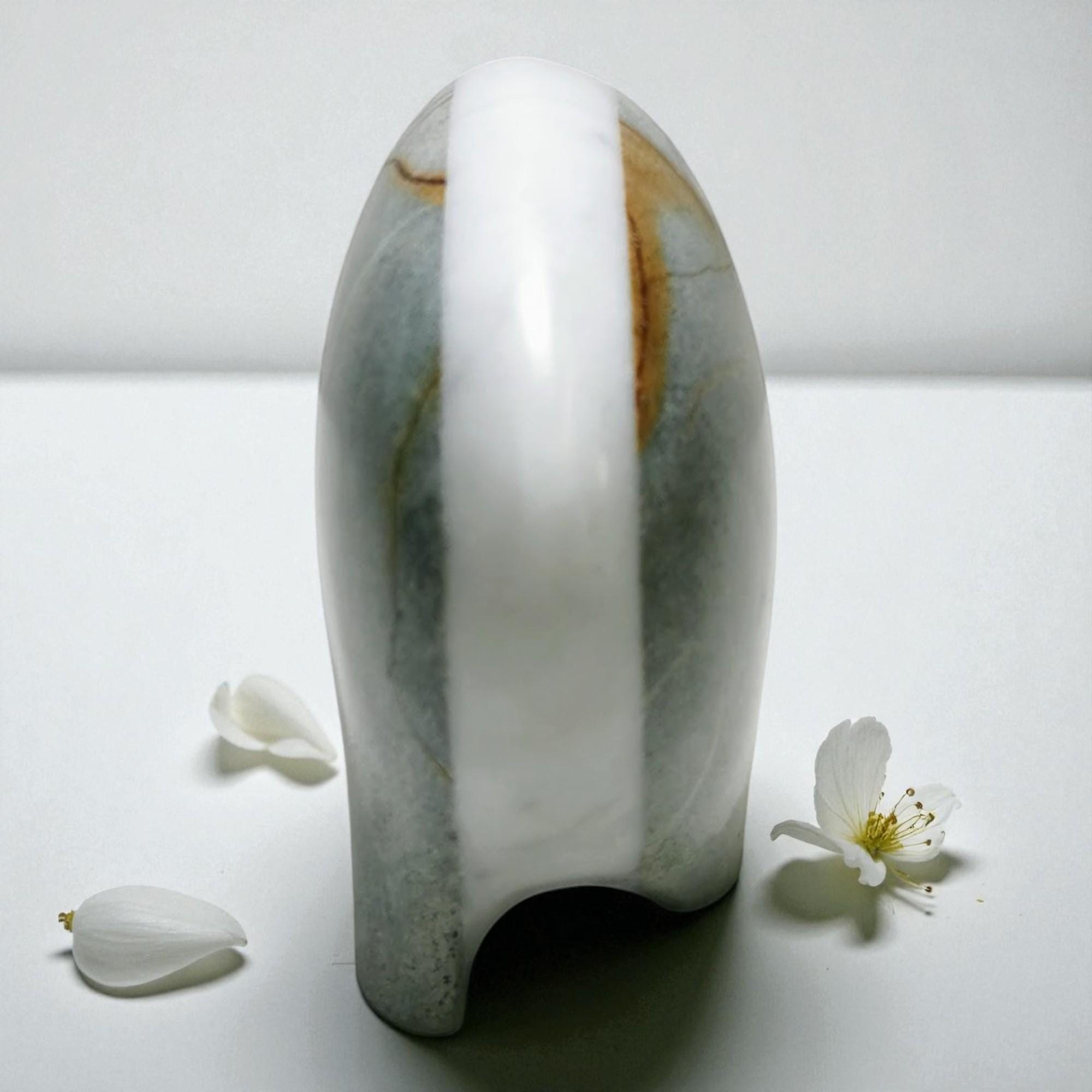Marble-patterned ceramic vase on a white surface with flowers
