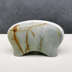 Decorative stone with brown veins on a gray background