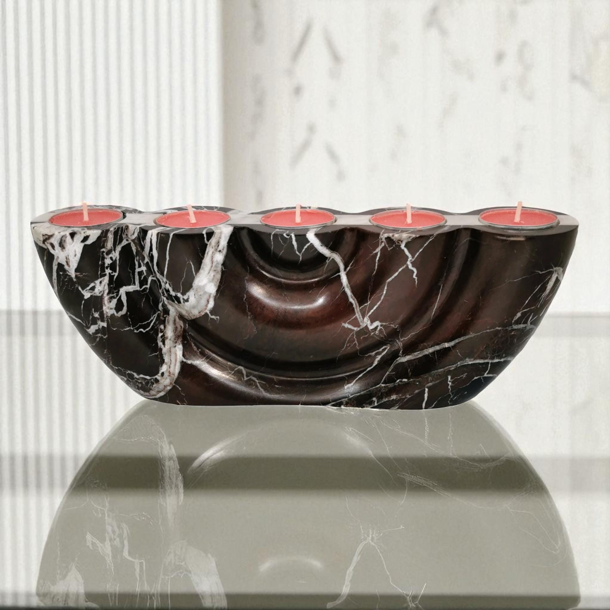 Marble-patterned candle holder with red candles on a light background