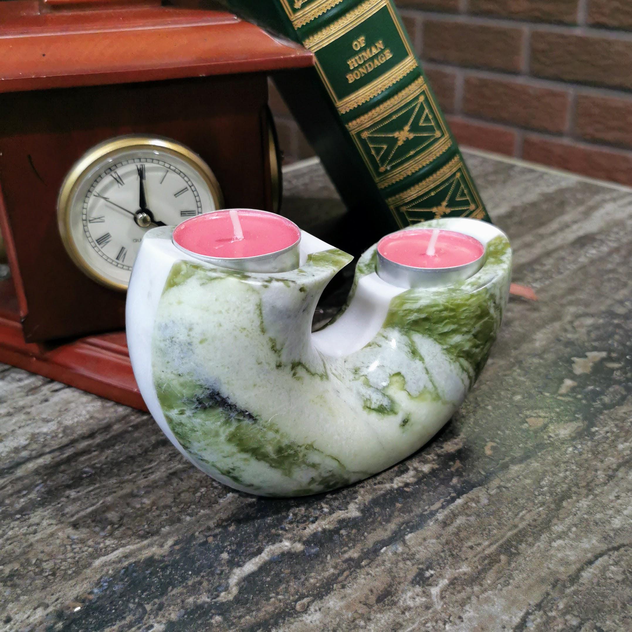 Rounded green marble tealight candle holder with smooth sculptural form, circular
candle indentation, luxury home decor, artisan-crafted
