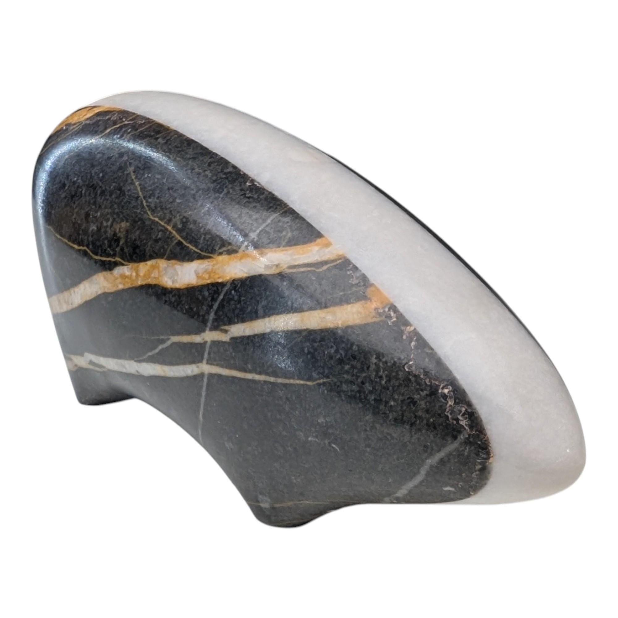 Polished stone with black, white, and gold colors on a white background