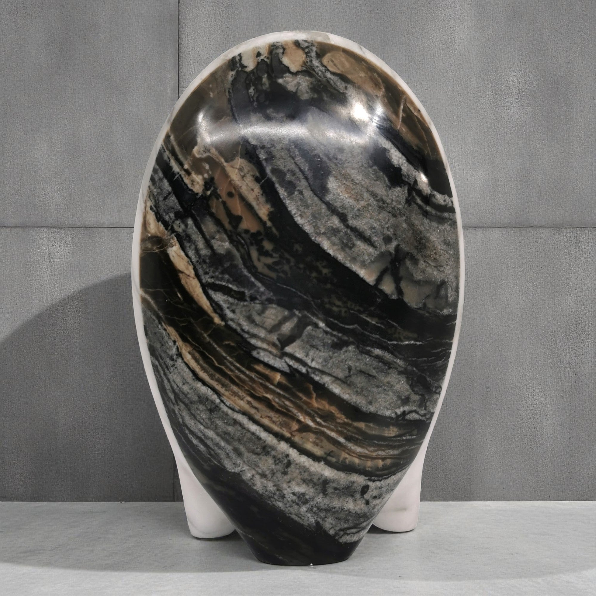 Marble-patterned vase on a gray surface with a gray background