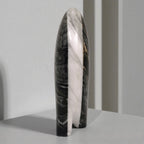 Marble-patterned cylindrical object on a gray background