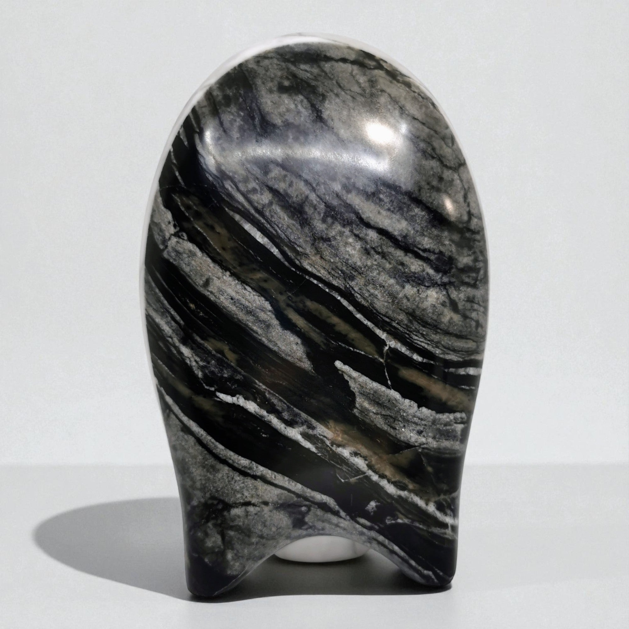 Marble-like stone sculpture on a white background