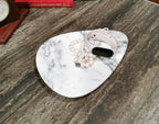 White marble jewelry tray, irregular shape, natural grey veining, polished surface