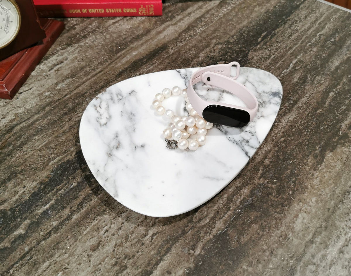White marble jewelry tray, irregular shape, natural grey veining, polished surface
