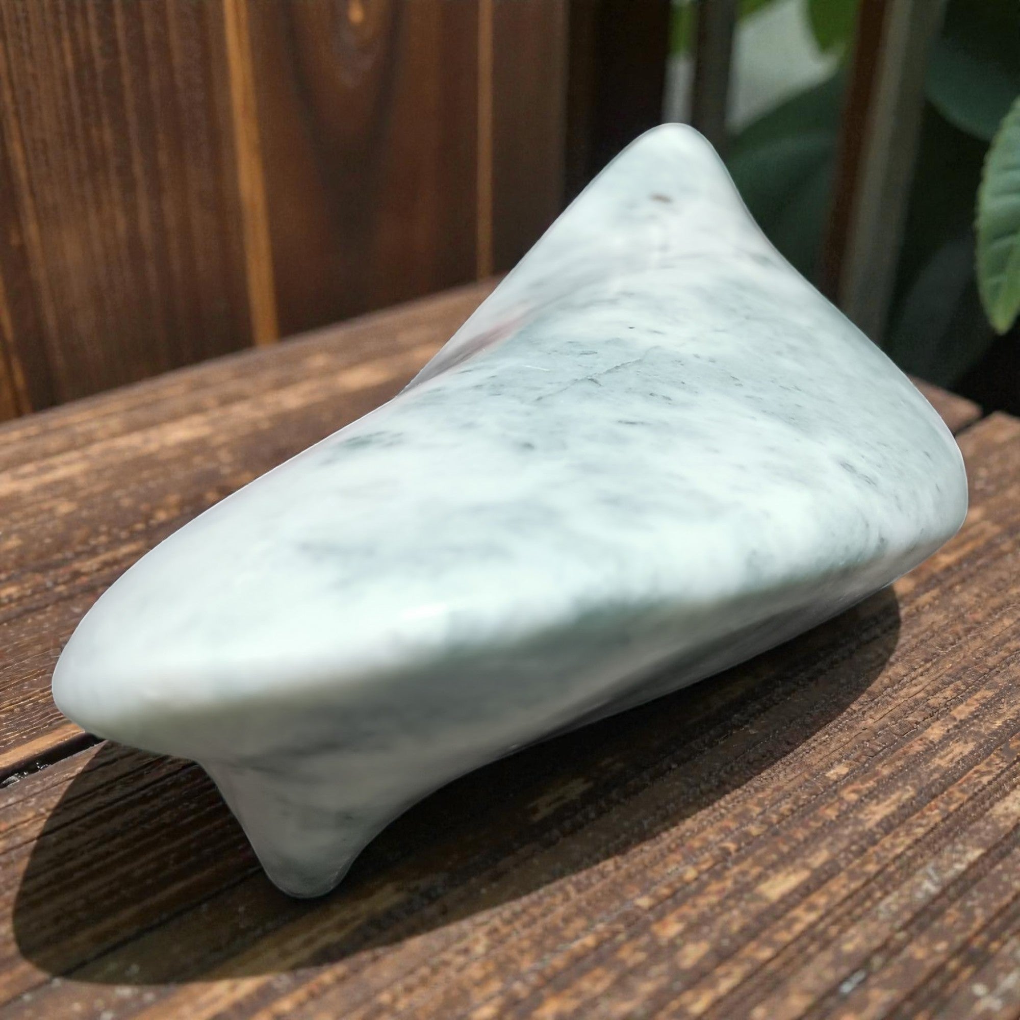 Marble-patterned soap bar on a wooden surface