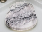 Marble-patterned cutting board on a white surface