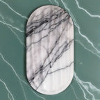 Marble-patterned oval object on a green marble background