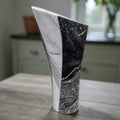 Dark flame abstract marble sculpture with angular form, black and white stone with
dramatic veining, contemporary art home decor piece, hand-carved