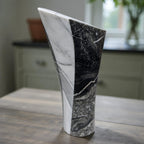 Dark flame abstract marble sculpture with angular form, black and white stone with
dramatic veining, contemporary art home decor piece, hand-carved