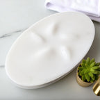 White marble tray on a marble surface with a potted plant