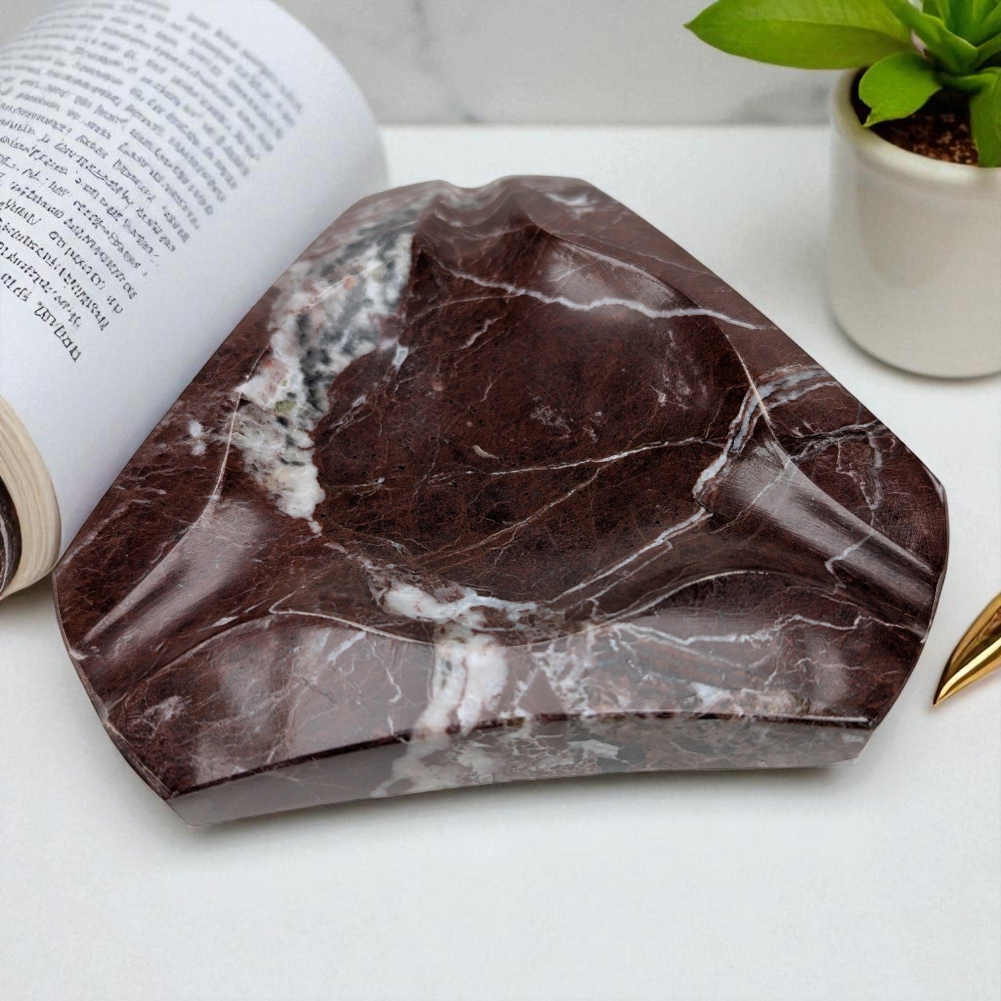 Geometric marble ashtray with angular form, polished stone, contemporary luxury decor
