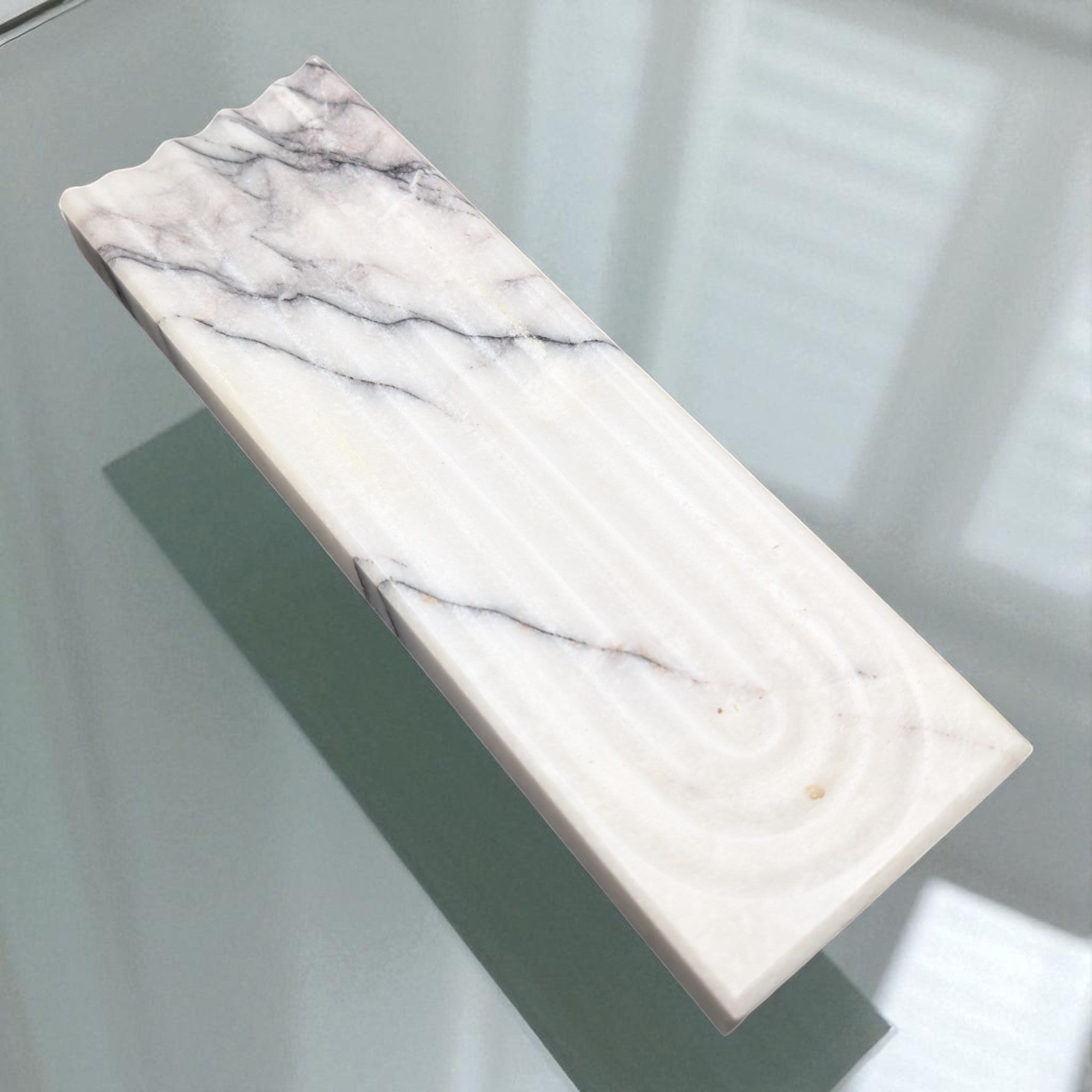 Marble-patterned soap bar on a light gray background