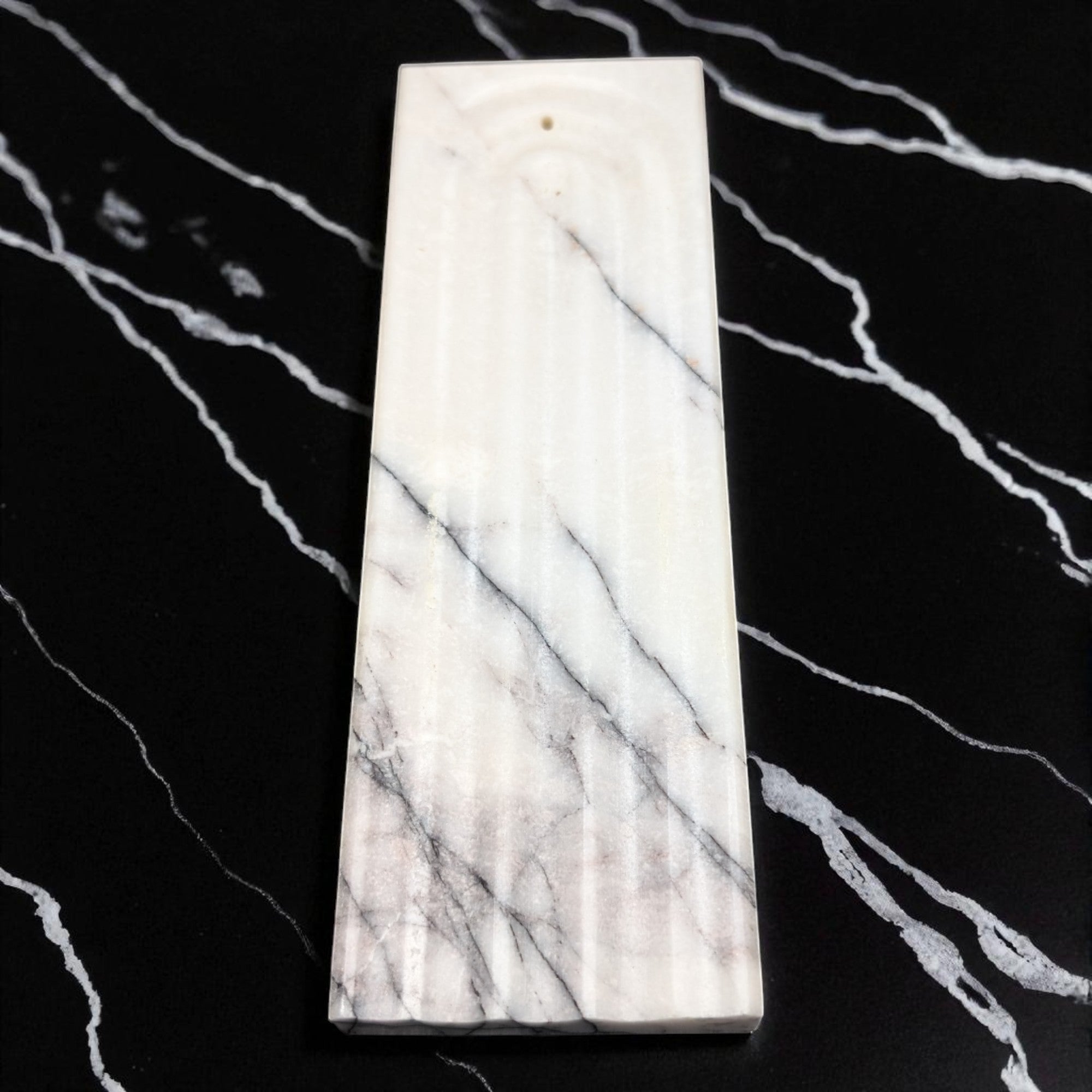 Marble-patterned rectangular object on a black and white marbled background