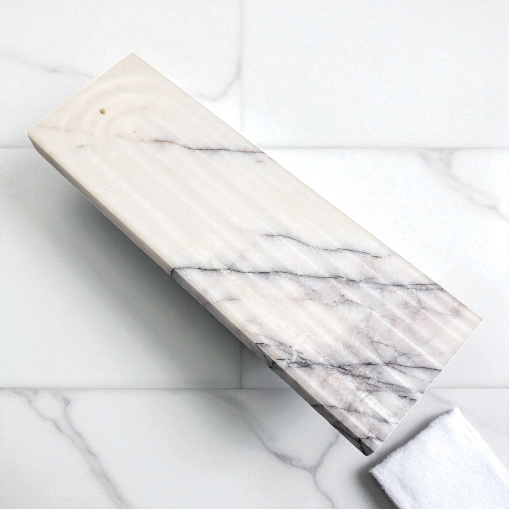 Marble-patterned incence stand on a marble surface