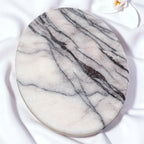 Round marble coaster with gray and white pattern on a white background