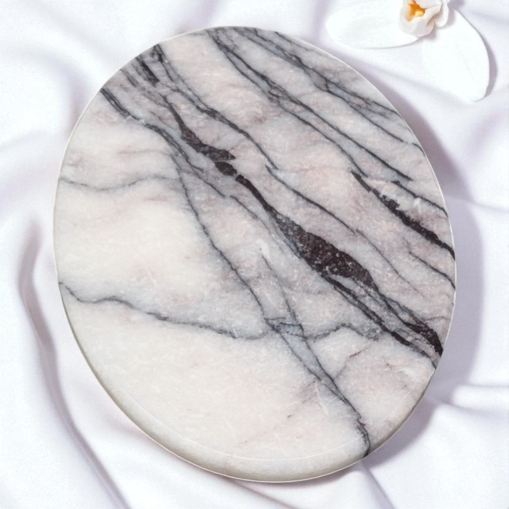 Round marble coaster with gray and white pattern on a white background