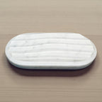 Marble-patterned soap dish on a beige surface