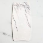Oval marble jewelry tray from above, light grey background