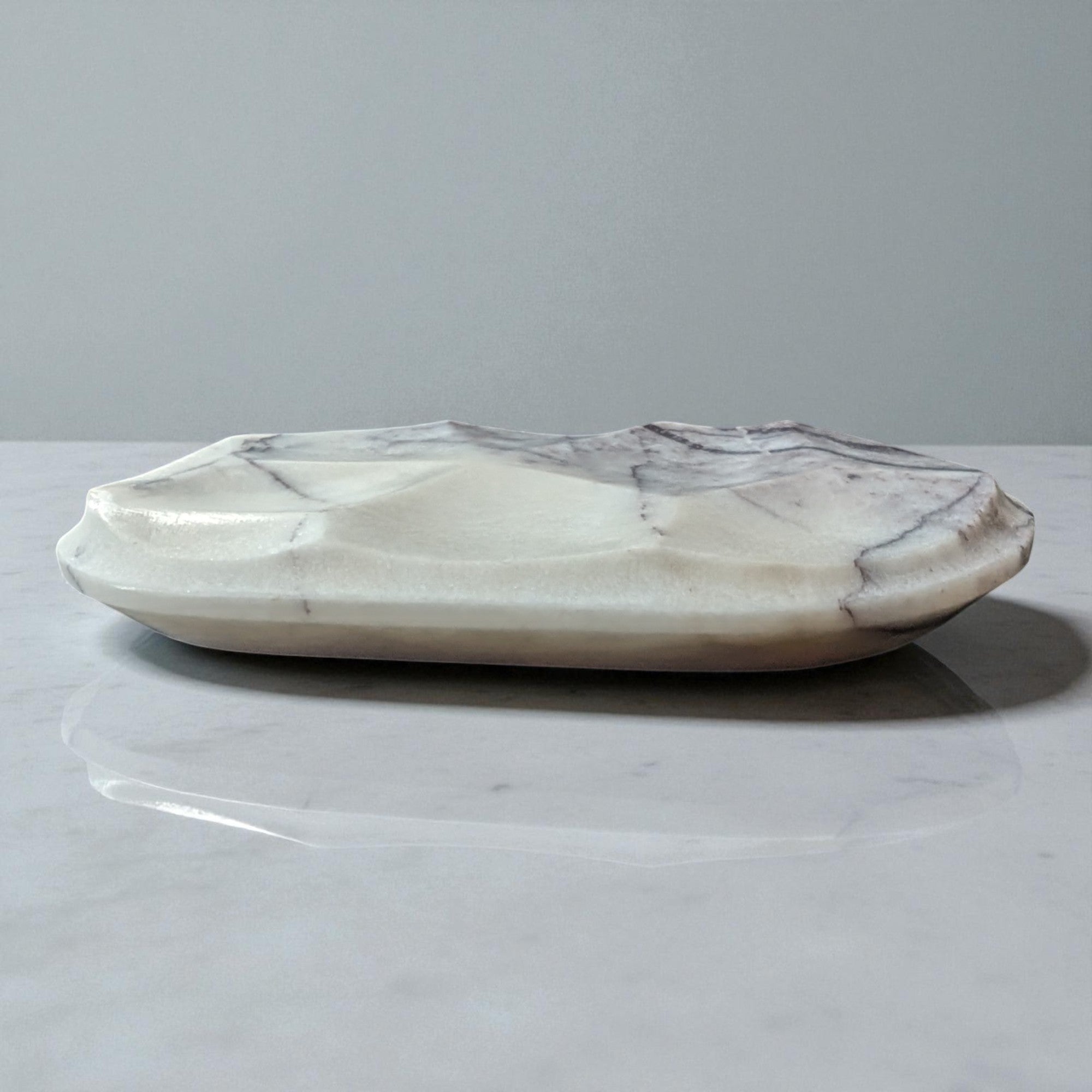 Marble-patterned ceramic dish on a light gray background
