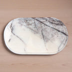 Marble-patterned cutting board on a wooden surface