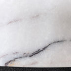 Close-up of the oval marble tray surface, grey and white veining