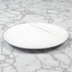 White ceramic plate on a marble surface