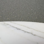 Close-up of a marble surface with a gray concrete background