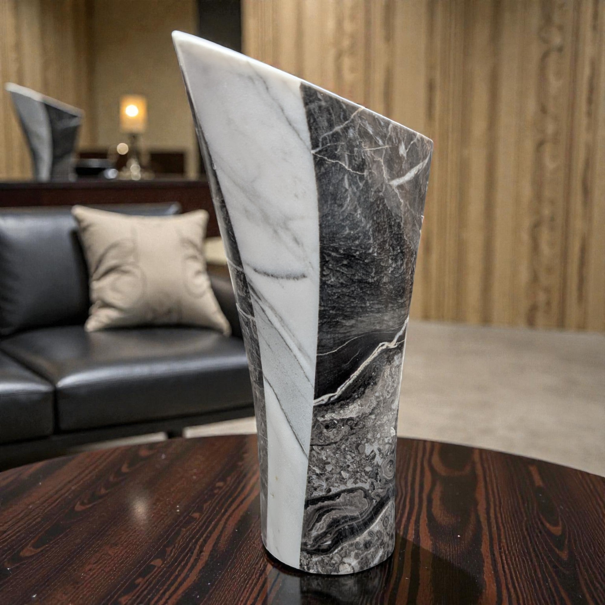 Marble-patterned vase on a wooden table with a blurred living room background