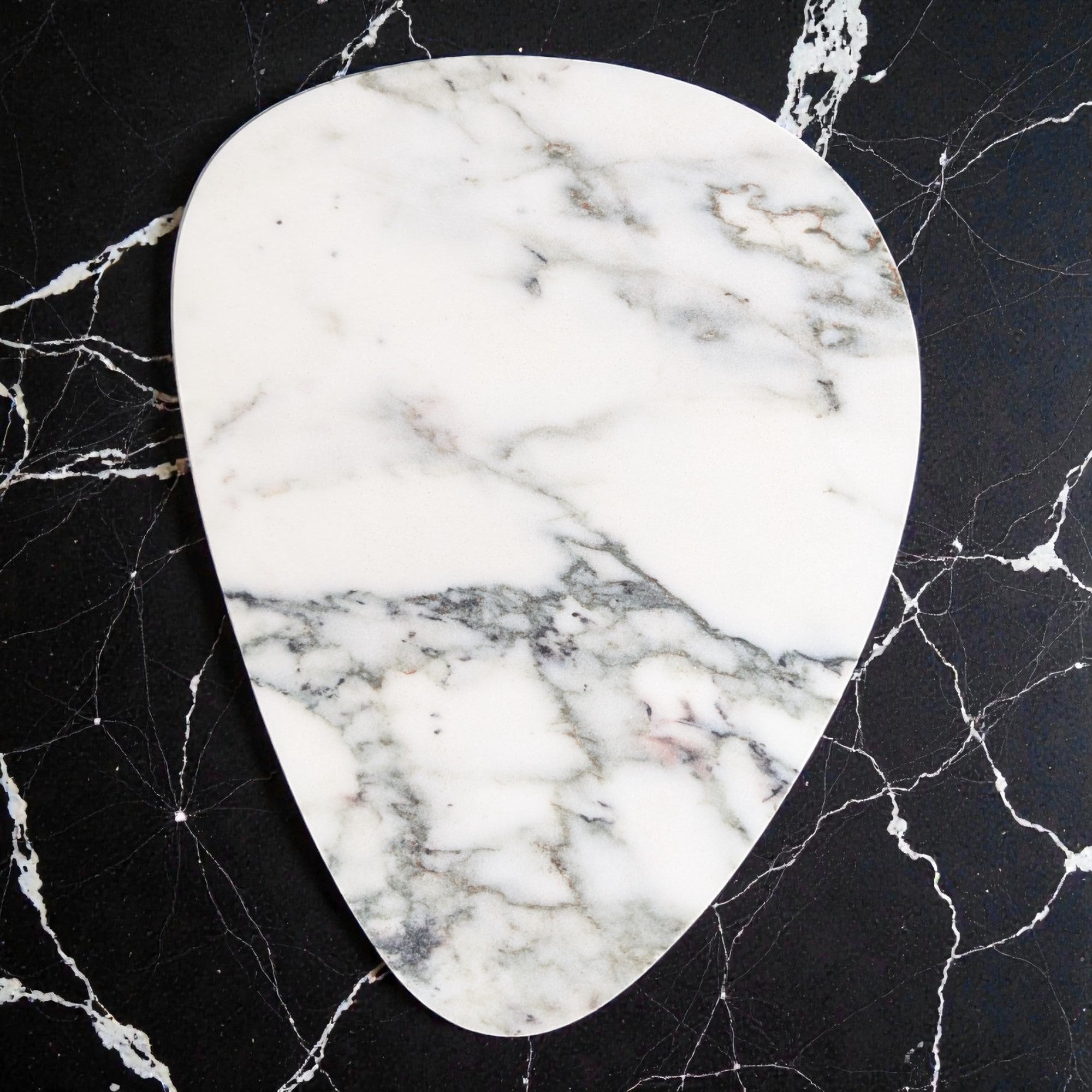 Marble-patterned stone on a black marble surface