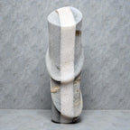 Marble vase with a textured surface on a gray background