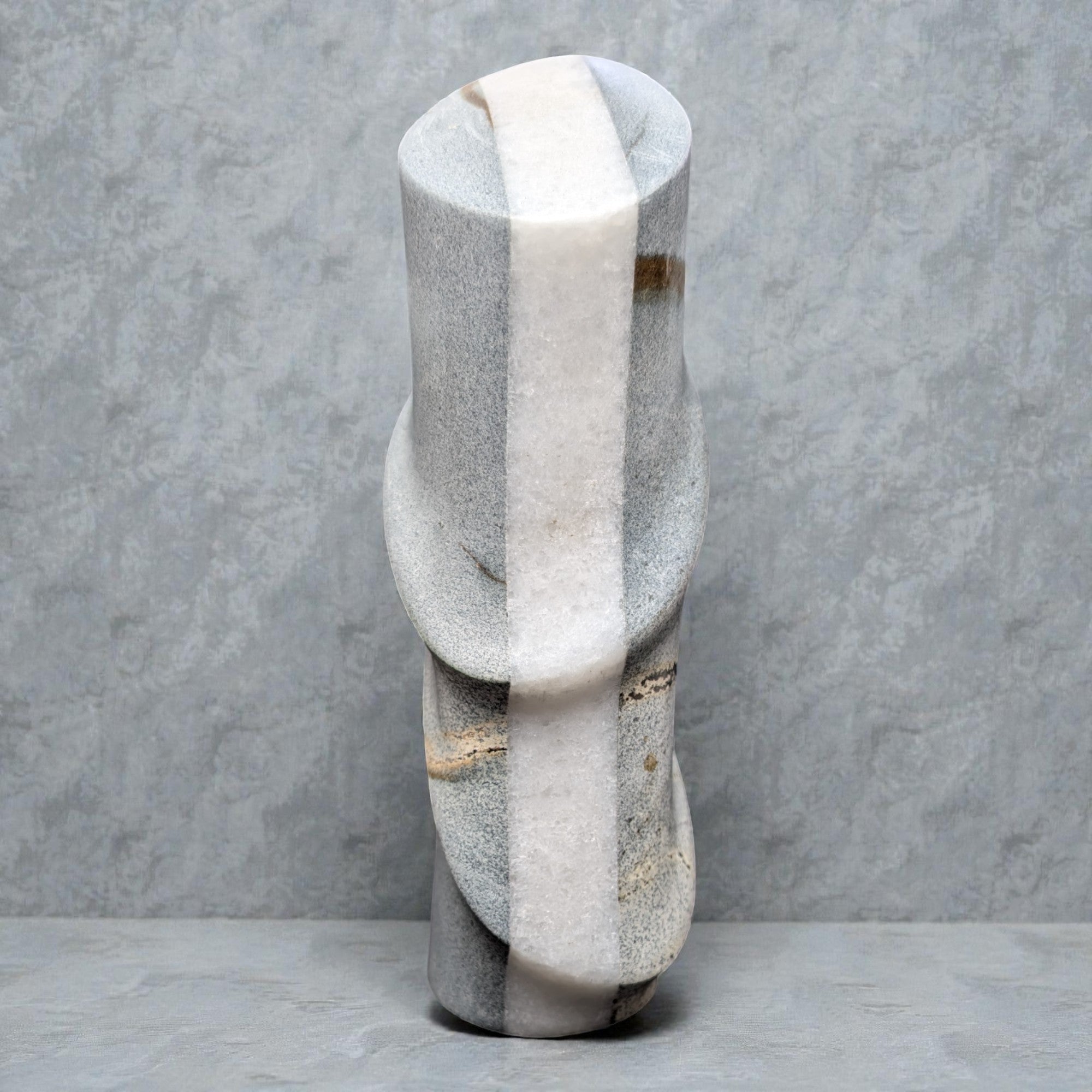 Marble vase with a textured surface on a gray background