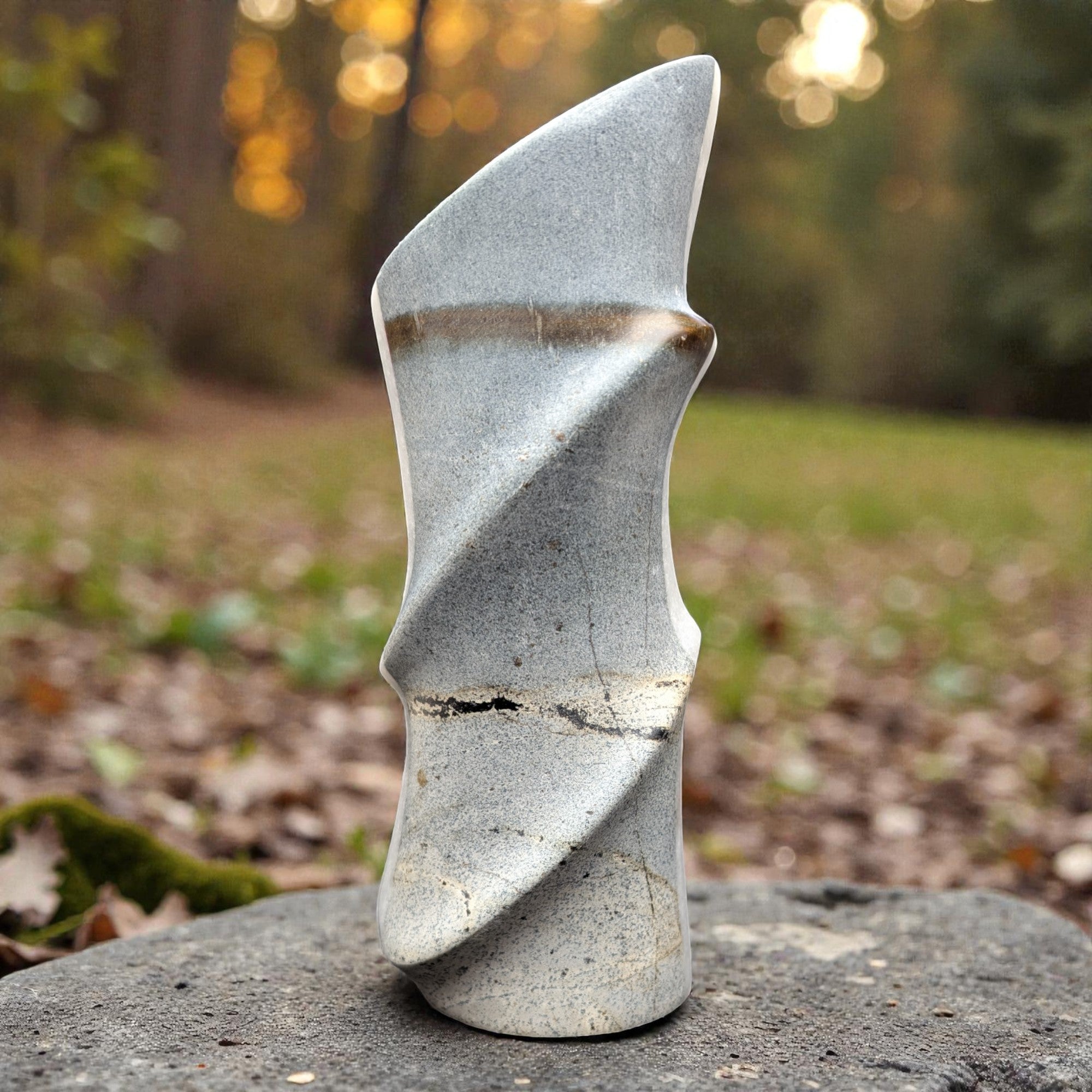 Abstract stone sculpture on a rock with a natural background
