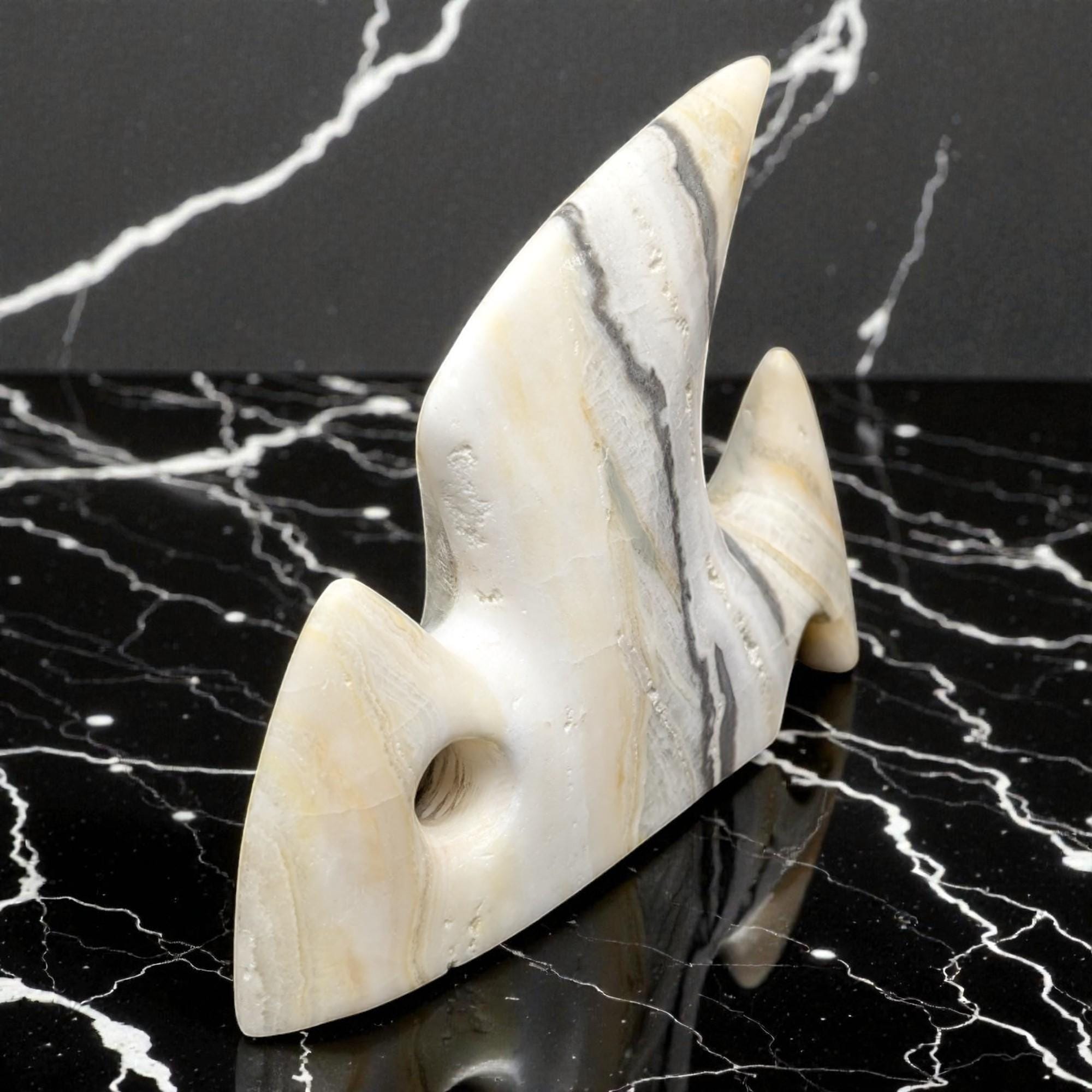 Marble-patterned stone sculpture on a black marble surface